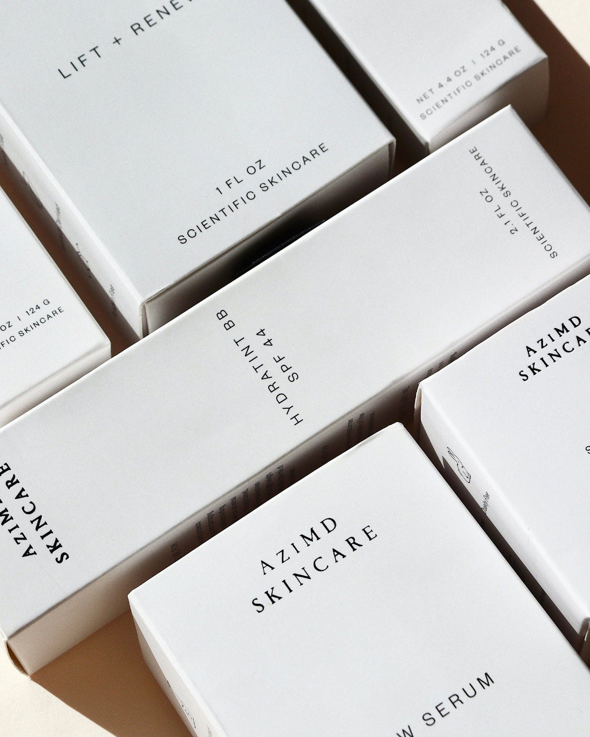 Close-up of Azimid Skincare product boxes with text on a neutral background